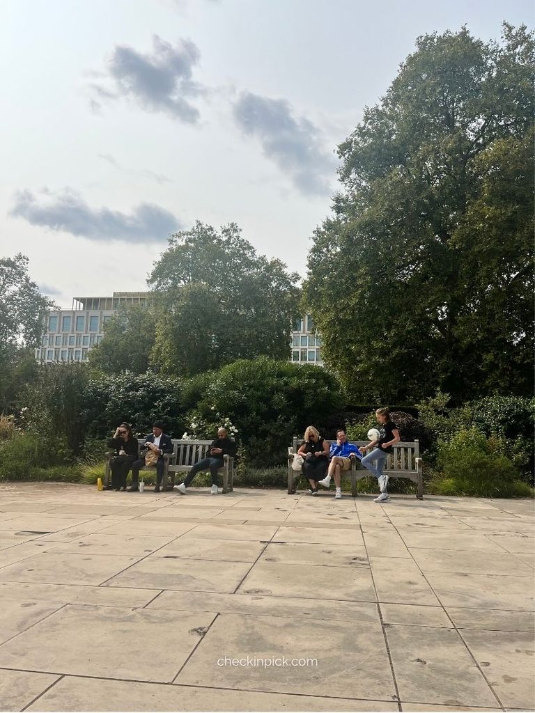 People sitting on benches in Grosvenor Square, London