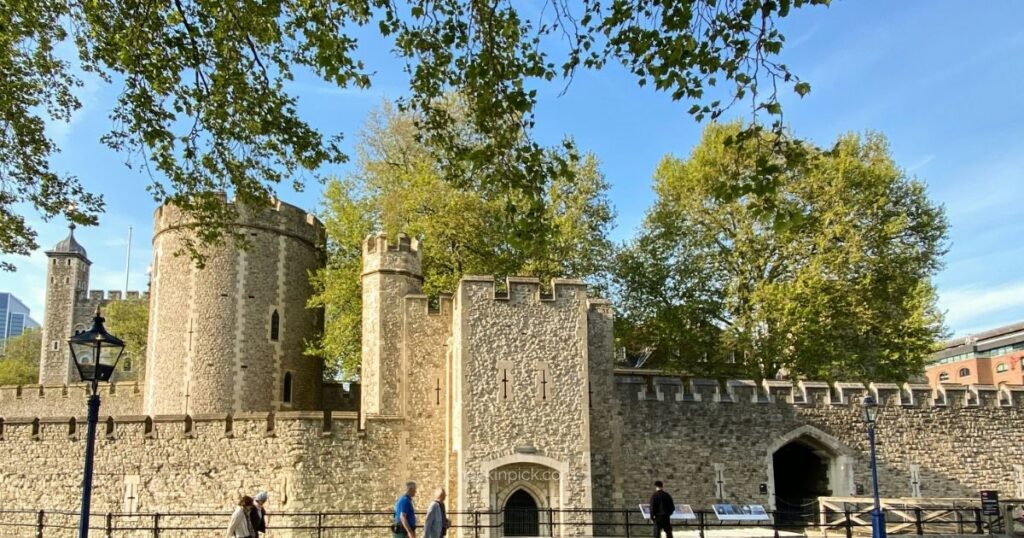 Visitors walking through the historic Tower of London fortress
