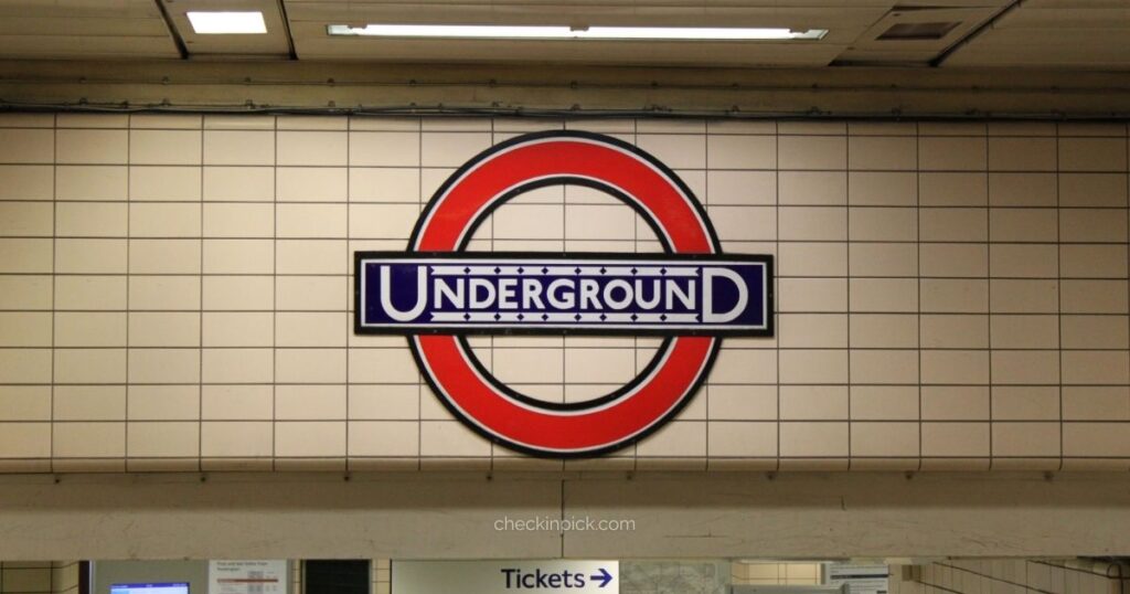 London Underground roundel sign inside subway station for Oyster Card travel guide