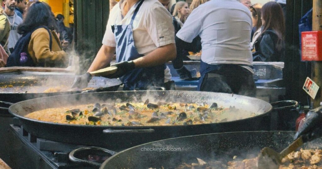Visitors enjoying food stalls at Borough Market in London.