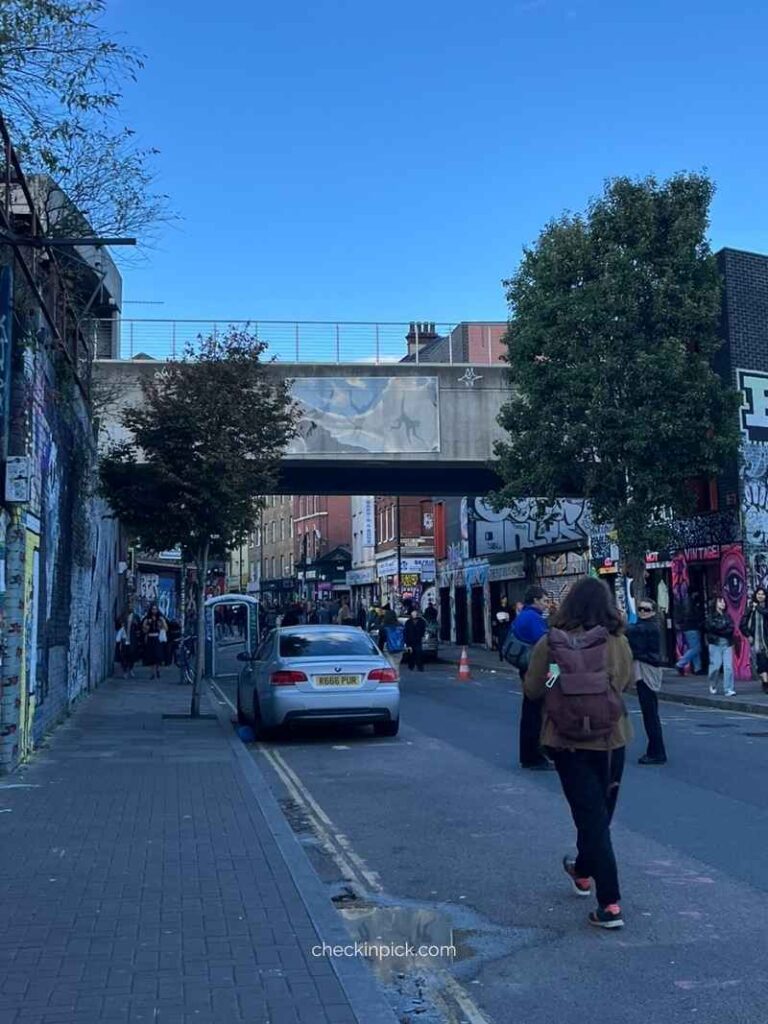 Three Monkeys street art on the railway bridge at Brick Lane, London