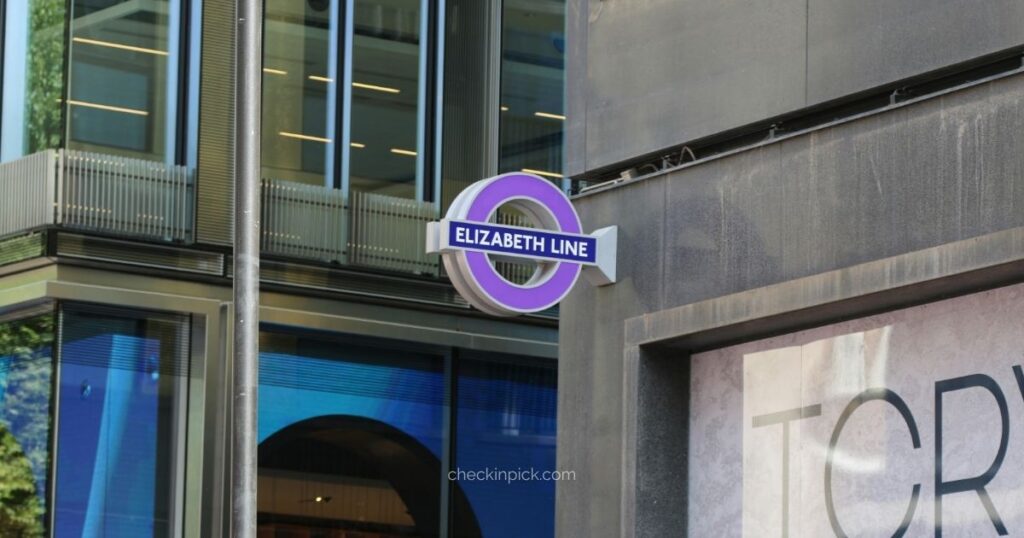 How to use the Elizabeth Line in London featuring purple Elizabeth Line station sign outside station entrance