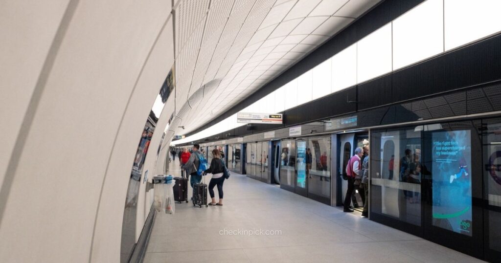 How to use the Elizabeth Line in London showing passengers waiting on modern platform as train arrives