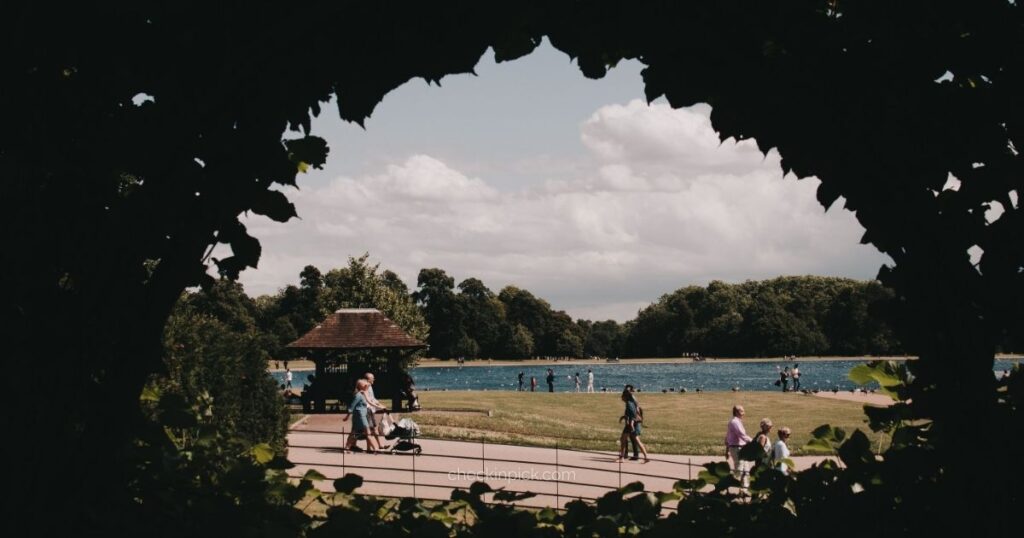 Visitors relaxing beside the Serpentine Lake in Hyde Park.