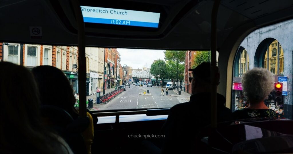 Passengers riding a London double-decker bus
