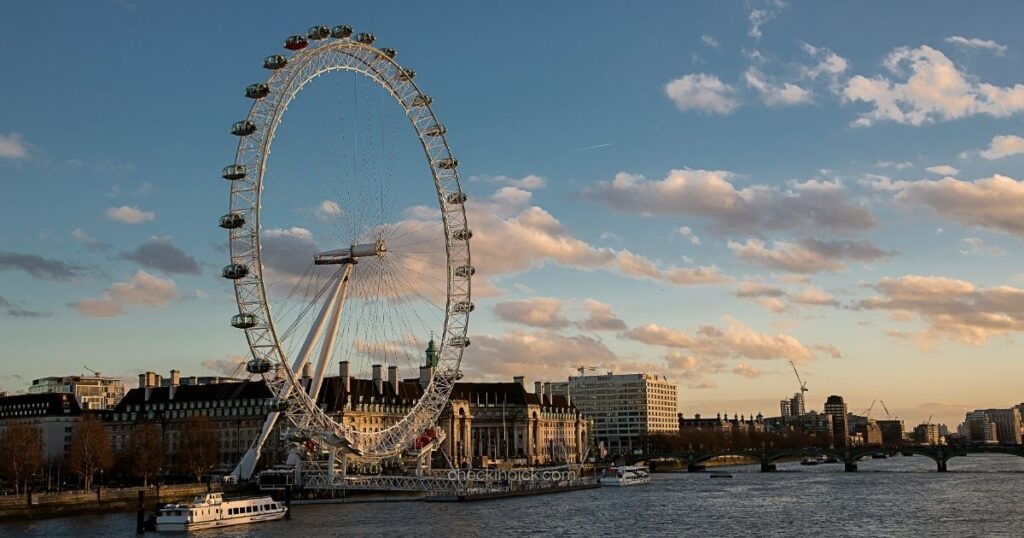 The London Eye overlooking the River Thames at sunset.