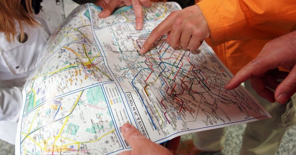 London travel zones explained featuring tourists pointing at the London Underground tube map