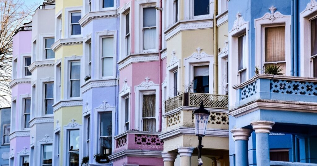 Colorful Victorian houses lining a quiet street in Notting Hill.