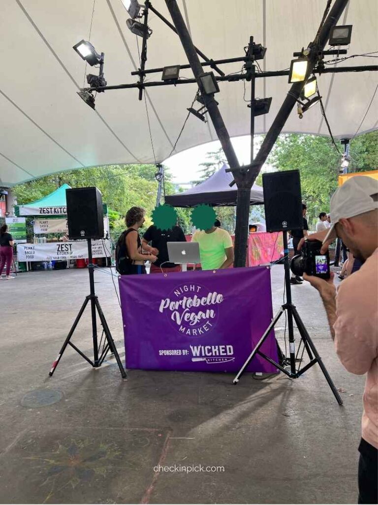 DJ performing at the Night Portobello Vegan Market under a canopy in London