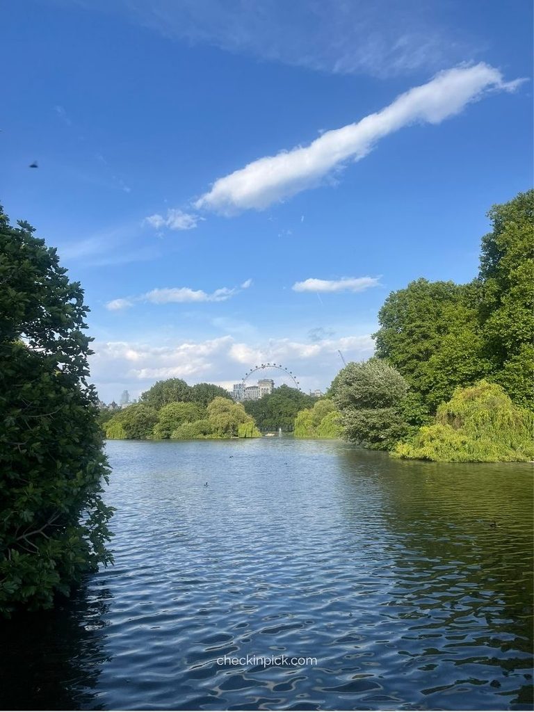 A peaceful view of St James’s Park, where lush green trees meet the tranquil lake.